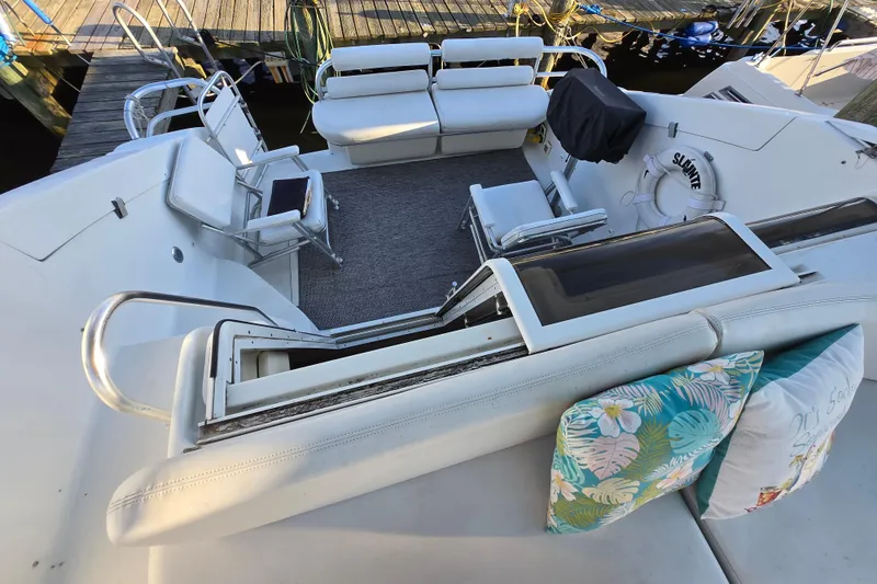 Slide: The Image of 1991 Mainship 35 Open Bridge yacht with spacious seating and decorative cushions. - 6