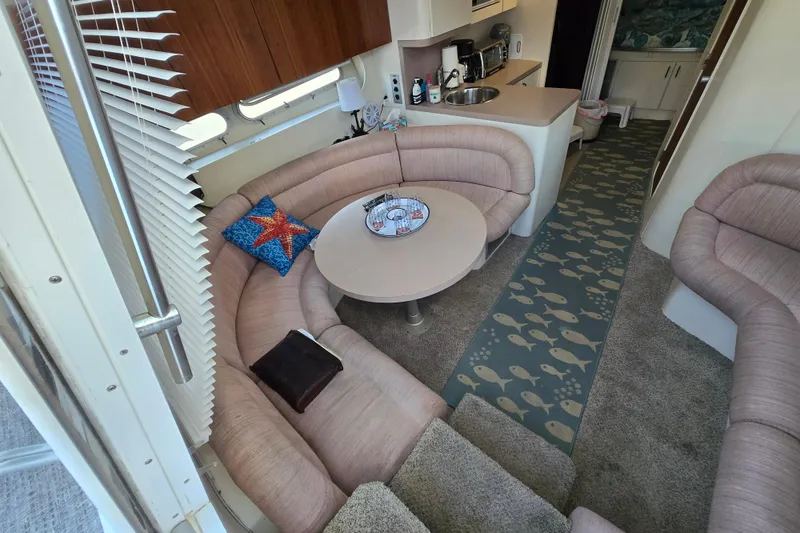 Slide: The Image of Interior of 1991 Mainship 35 Open Bridge yacht with cozy seating and nautical decor. - 9