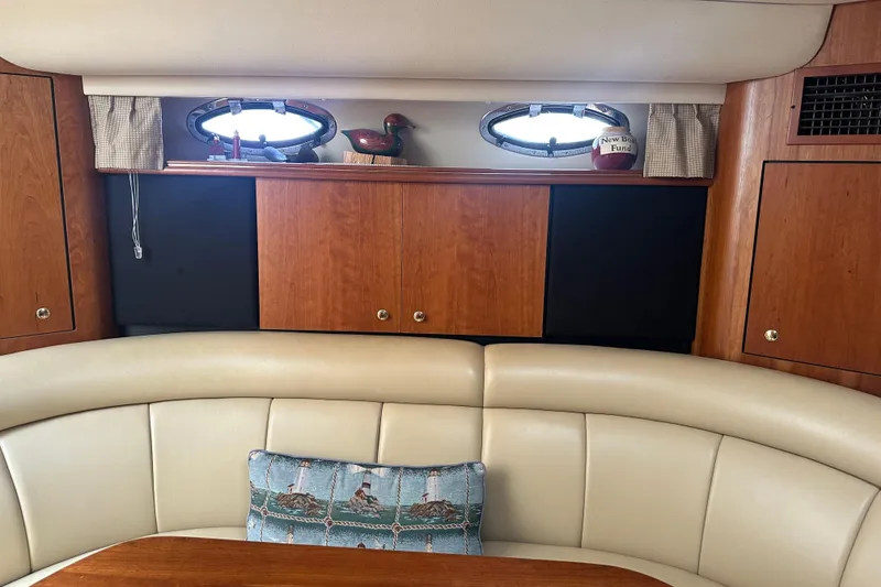 Slide: The Image of Interior of 2001 Cruisers Yachts 3870 Express with wood cabinets and leather seating. - 4