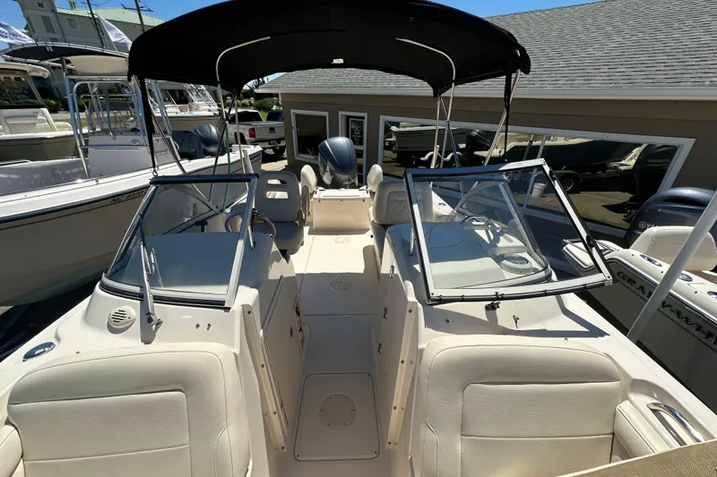 Slide: The Image of 2018 Grady-White Freedom 215 boat with open deck and canopy, docked at marina. - 13