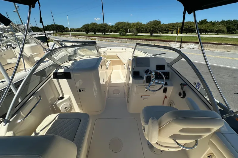 Slide: The Image of 2018 Grady-White Freedom 215 boat interior with steering wheel and seating. - 14