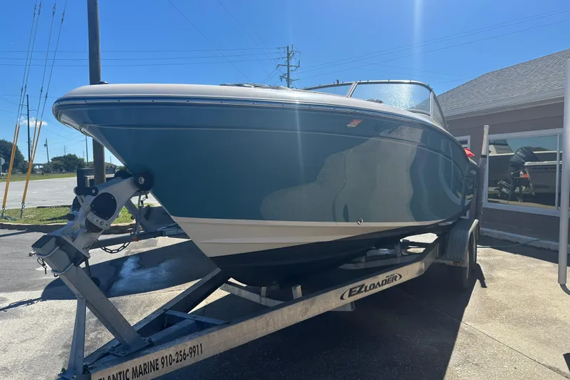 Slide: The Image of 2018 Grady-White Freedom 215 boat on trailer, parked outdoors in sunlight. - 2