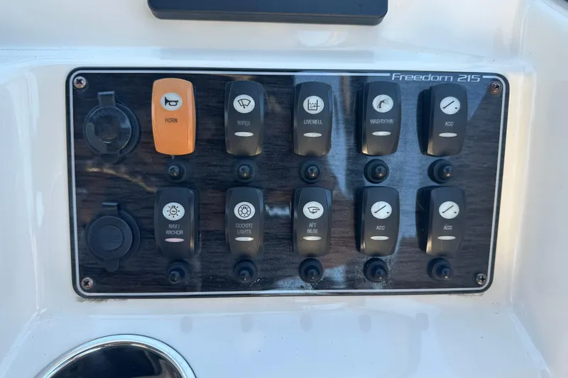 Slide: The Image of Control panel of 2018 Grady-White Freedom 215 boat with labeled switches. - 20