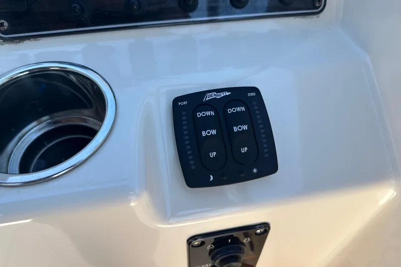 Slide: The Image of Control panel on 2018 Grady-White Freedom 215 boat with trim tab switches. - 21