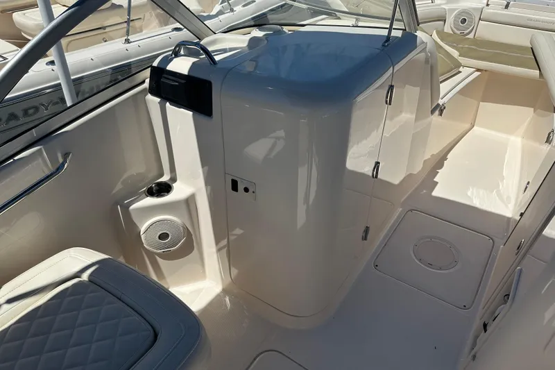 Slide: The Image of 2018 Grady-White Freedom 215 boat interior with seating and storage compartments. - 23