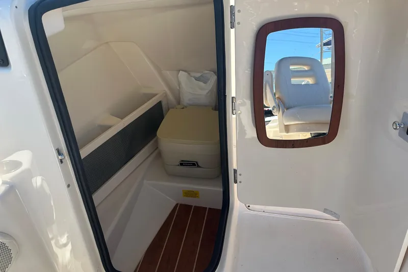 Slide: The Image of 2018 Grady-White Freedom 215 boat interior with mirror and storage area. - 25