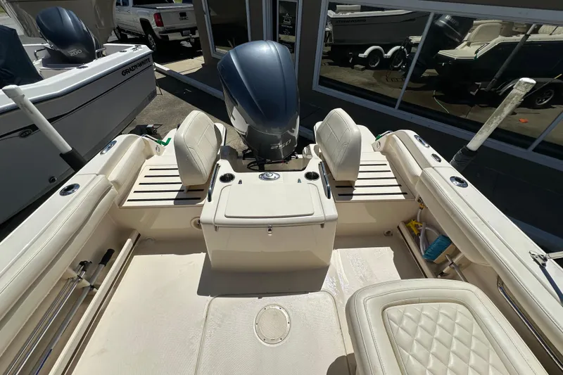 Slide: The Image of 2018 Grady-White Freedom 215 boat interior with seating and outboard motor. - 26