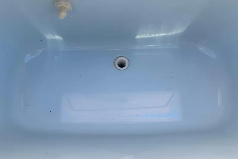 Slide: The Image of 2018 Grady-White Freedom 215 boat interior, featuring a clean, empty compartment. - 28