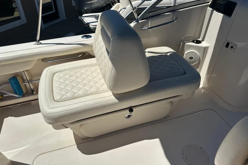 Slide: The Image of 2018 Grady-White Freedom 215 boat interior with white cushioned seating. - 34