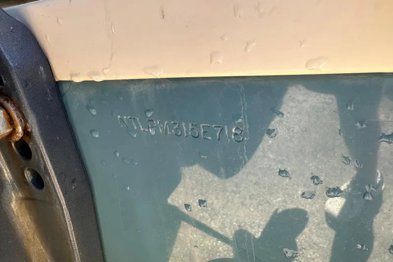 Slide: The Image of 2018 Grady-White Freedom 215 boat hull identification number with water droplets. - 4