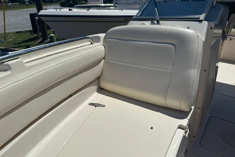 Slide: The Image of 2018 Grady-White Freedom 215 boat interior with white seating and sleek design. - 9