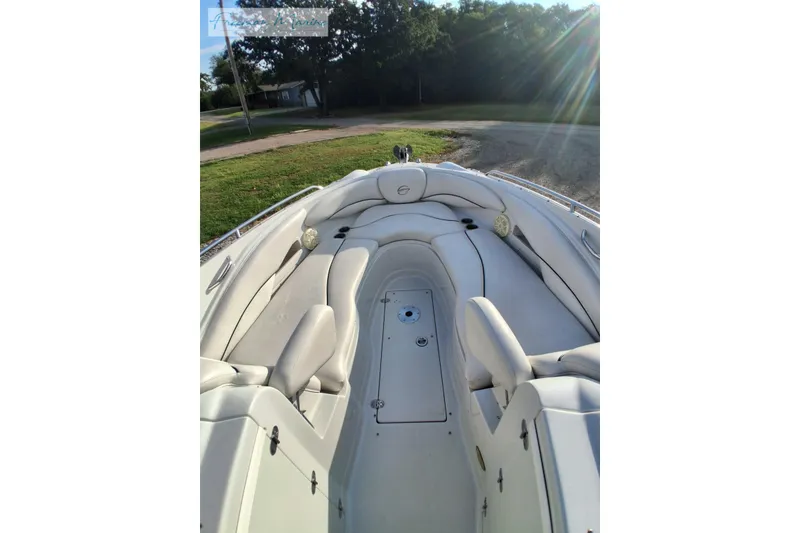 Slide: The Image of 2007 Crownline 320 LS boat interior with white seating and sunny outdoor setting. - 11