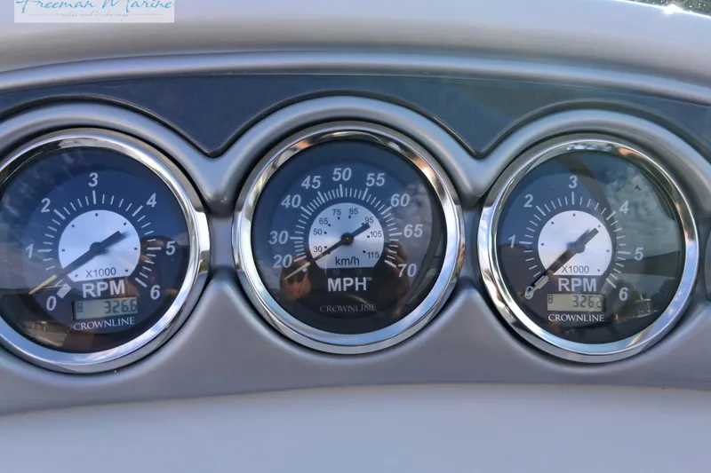 Slide: The Image of Dashboard gauges of a 2007 Crownline 320 LS boat showing RPM and speed. - 12