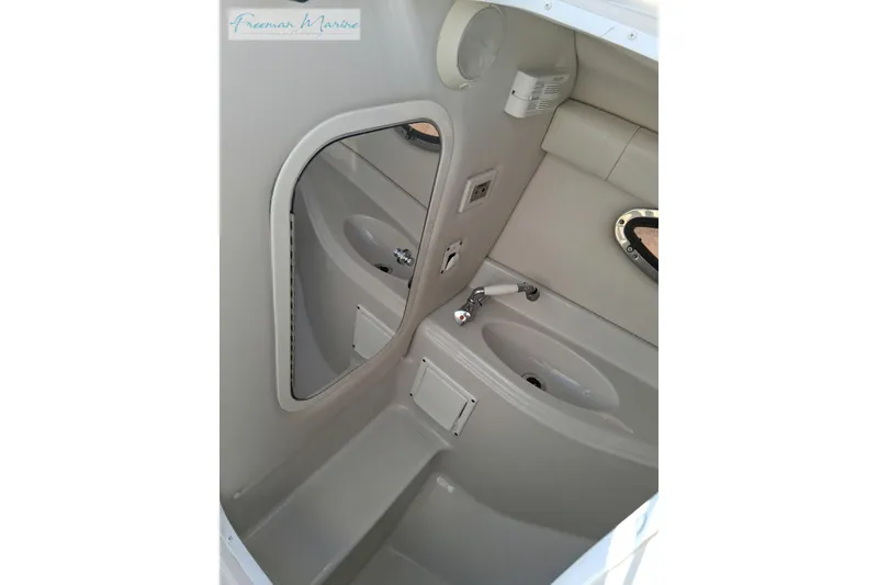 Slide: The Image of 2007 Crownline 320 LS boat interior bathroom with sink and mirror. - 19