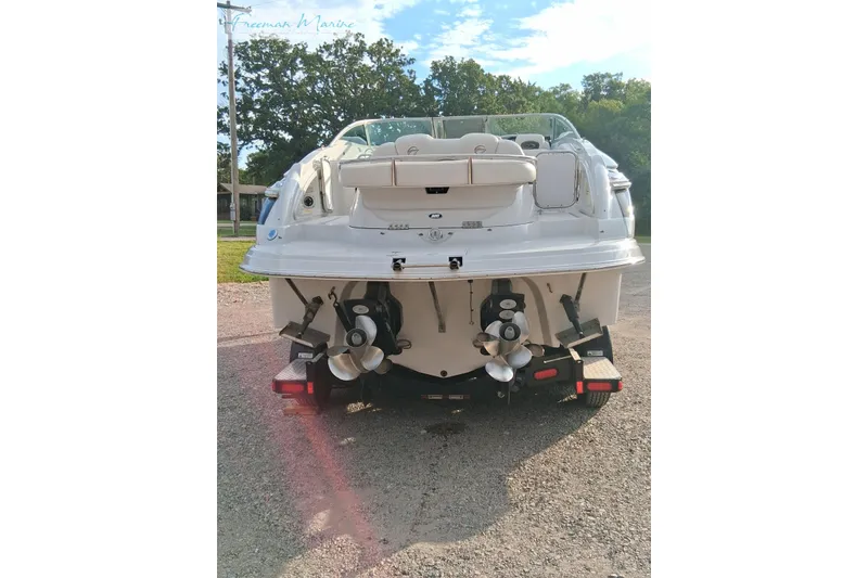Slide: The Image of 2007 Crownline 320 LS boat rear view with dual propellers on a trailer. - 2