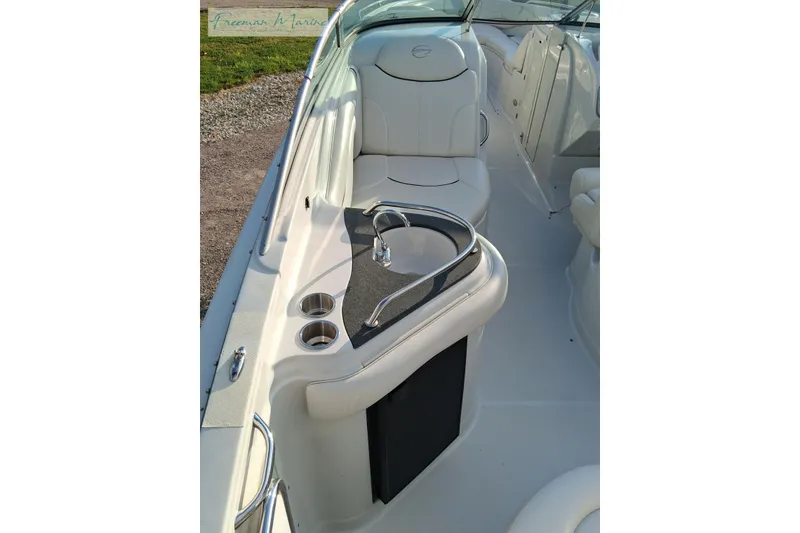 Slide: The Image of 2007 Crownline 320 LS boat interior with white seating and cup holders. - 20
