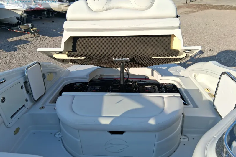 Slide: The Image of 2007 Crownline 320 LS boat engine compartment with open hatch, revealing dual engines. - 24