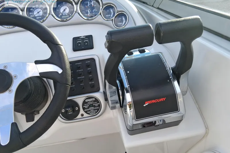 Slide: The Image of Steering wheel and controls of 2007 Crownline 320 LS boat with Mercury throttle. - 28