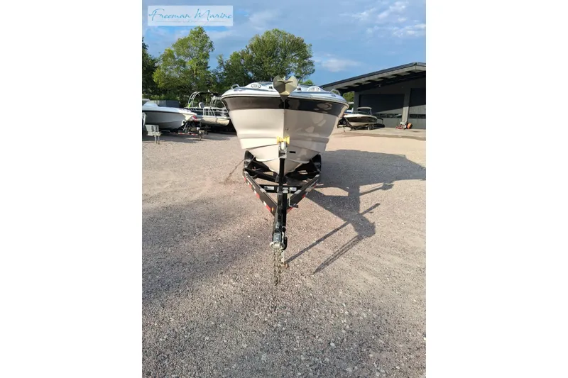 Slide: The Image of 2007 Crownline 320 LS boat on trailer in outdoor storage area. - 29