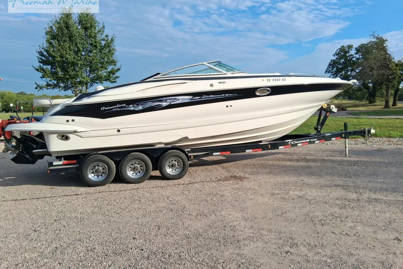 Slide: The Image of 2007 Crownline 320 LS boat on trailer, parked outdoors on gravel. - 3