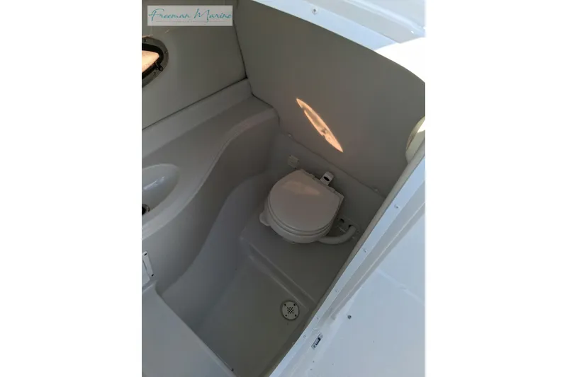 Slide: The Image of 2007 Crownline 320 LS boat interior with compact marine toilet. - 34