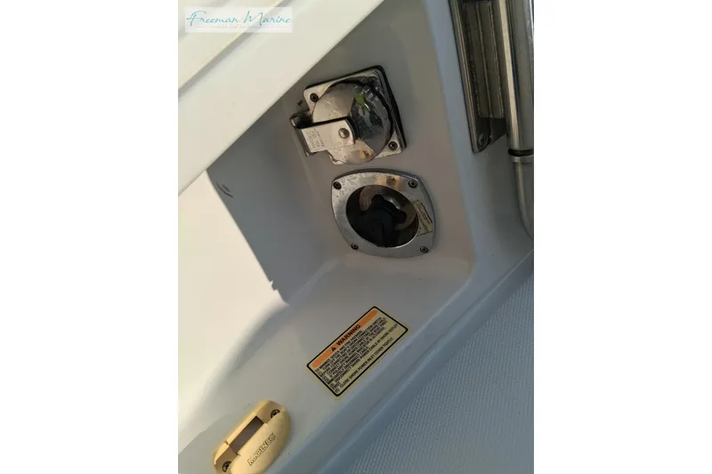 Slide: The Image of 2007 Crownline 320 LS boat fuel and water fill ports with warning label. - 37