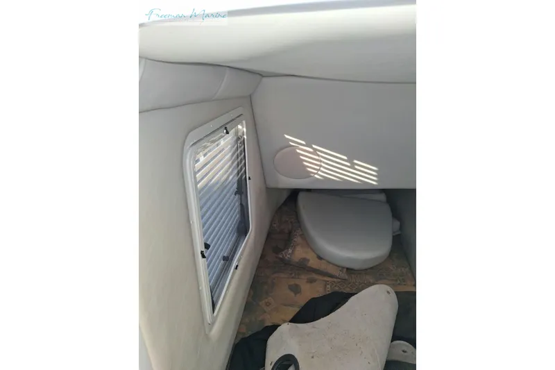 Slide: The Image of 2007 Crownline 320 LS boat interior with window and seating area. - 38