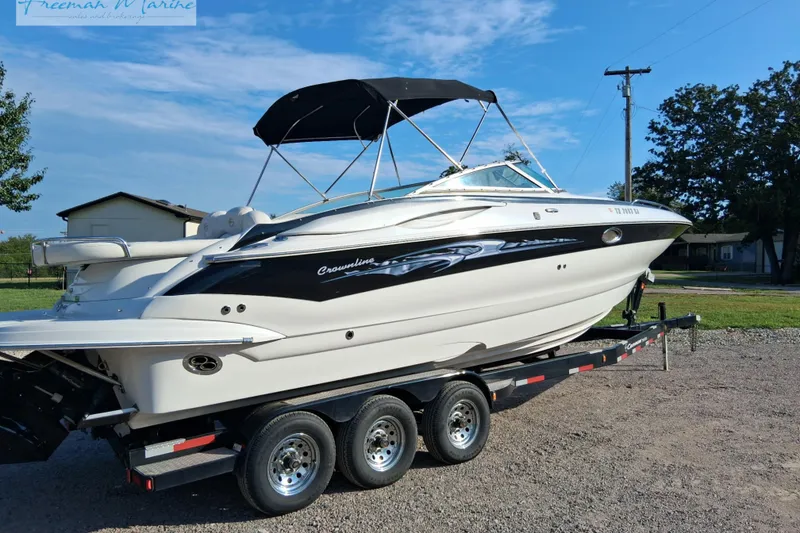 Slide: The Image of 2007 Crownline 320 LS boat on trailer with black canopy, parked outdoors. - 6