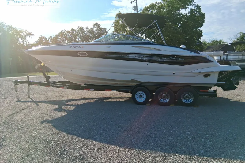 Slide: The Image of 2007 Crownline 320 LS boat on trailer, parked outdoors under clear sky. - 7