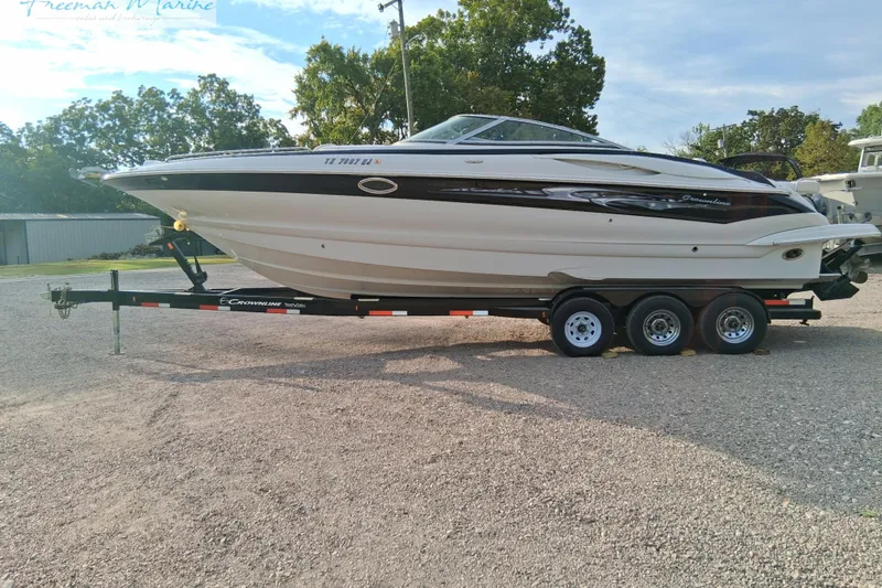 Slide: The Image of 2007 Crownline 320 LS boat on trailer, parked outdoors, side view. - 8