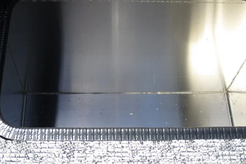 Slide: The Image of Interior of 2026 Tracker Pro Team 175 boat compartment, featuring a metallic finish. - 19