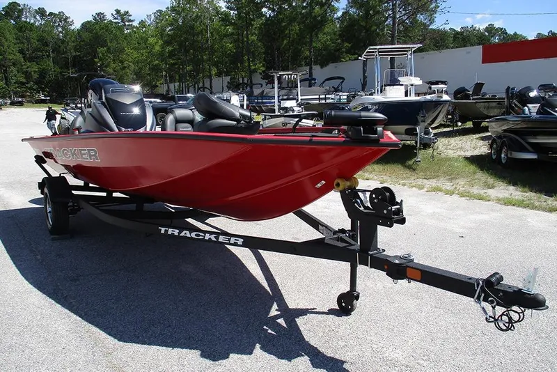 Slide: The Image of 2026 Tracker Pro Team 175 boat in vibrant red on a trailer, parked outdoors. - 3