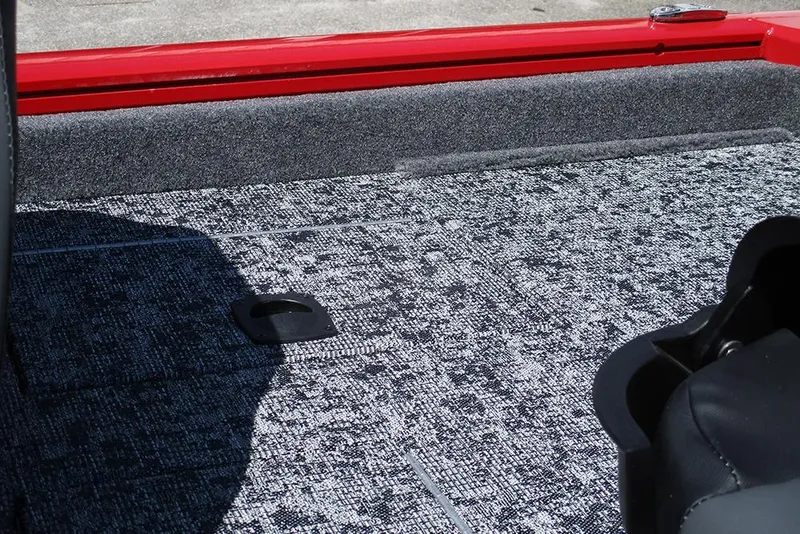 Slide: The Image of Interior view of 2026 Tracker Pro Team 175 boat with textured flooring and red trim. - 30