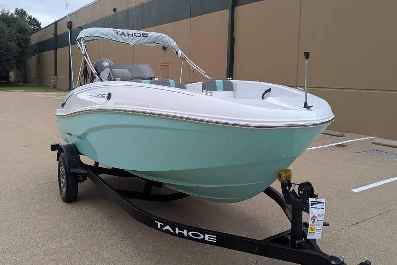 Slide: The Image of 2026 Tahoe T18 boat on trailer, light blue hull, parked outdoors. - 3