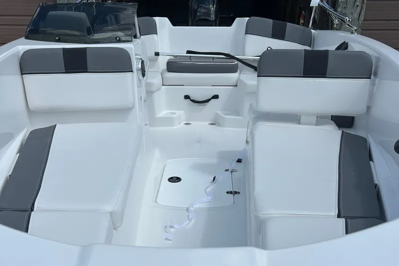 Slide: The Image of 2026 Tahoe T16 boat interior with white and gray seating, modern design. - 2