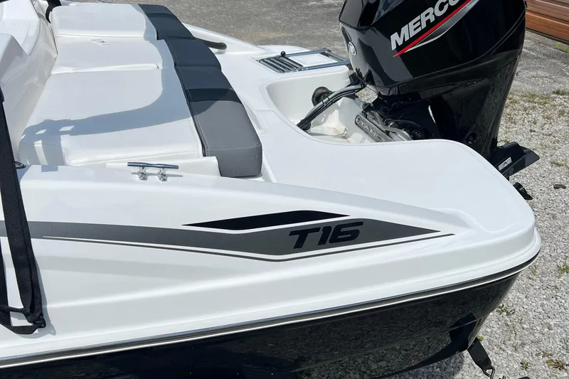 Slide: The Image of 2026 Tahoe T16 boat with Mercury engine, white and black design, rear seating area. - 4