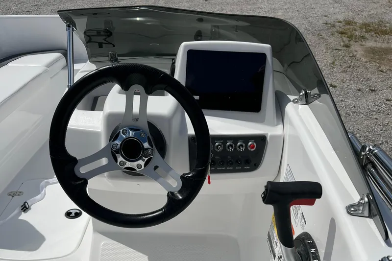 Slide: The Image of Steering console of 2026 Tahoe T16 boat with modern controls and display. - 7