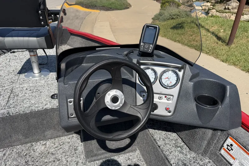 Slide: The Image of 2026 Tracker Pro Guide V-16 SC boat dashboard with steering wheel and navigation system. - 15