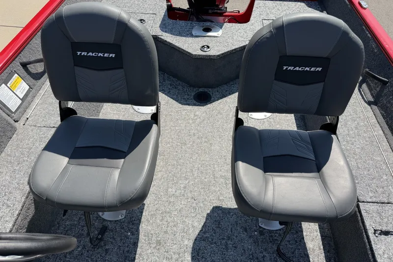 Slide: The Image of Two gray seats in a 2026 Tracker Pro Guide V-16 SC boat interior. - 14