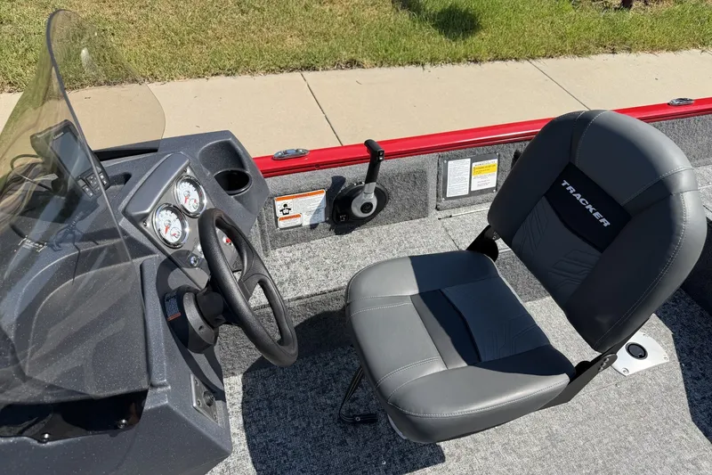 Slide: The Image of 2026 Tracker Pro Guide V-16 SC boat interior with steering wheel and seat. - 16