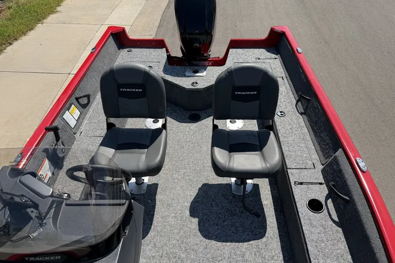 Slide: The Image of 2026 Tracker Pro Guide V-16 SC boat interior with two seats and steering console. - 13