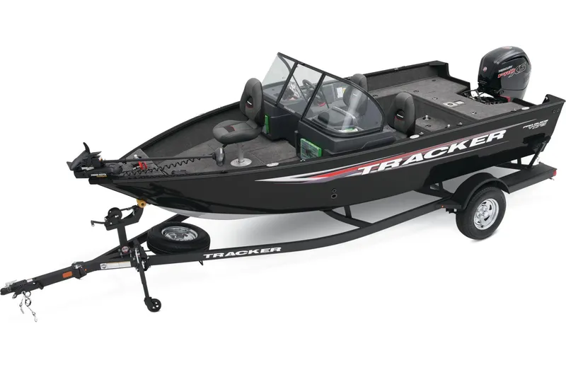 Slide: The Image of 2026 Tracker Pro Guide V-175 WT boat interior with motor, gray seating, and storage compartments. - 4