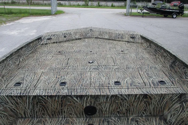 Slide: The Image of 2026 Tracker Grizzly 2072 CC boat with camouflage pattern in a parking area. - 10