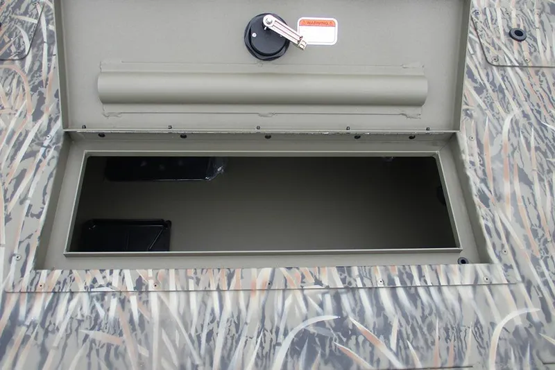 Slide: The Image of Open storage compartment on 2026 Tracker Grizzly 2072 CC boat with camouflage pattern. - 12