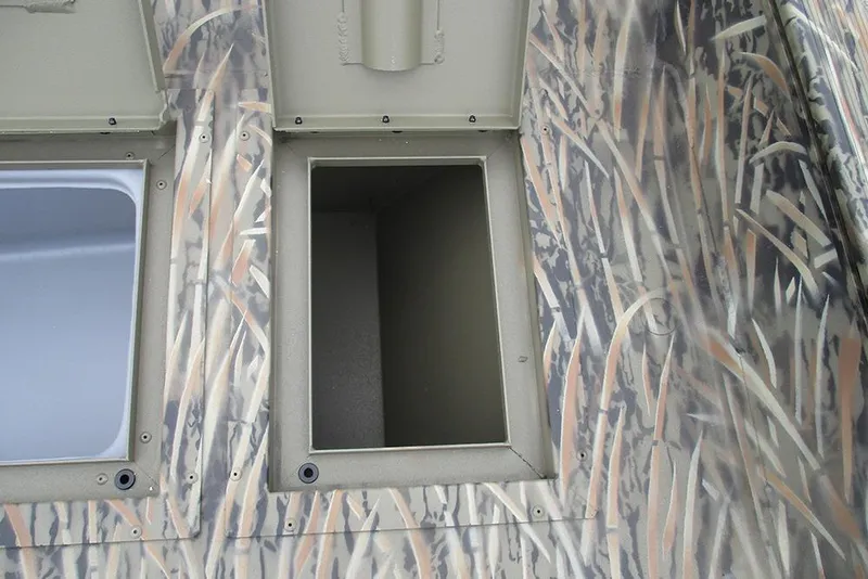 Slide: The Image of Open storage compartment on 2026 Tracker Grizzly 2072 CC boat with camo pattern. - 14