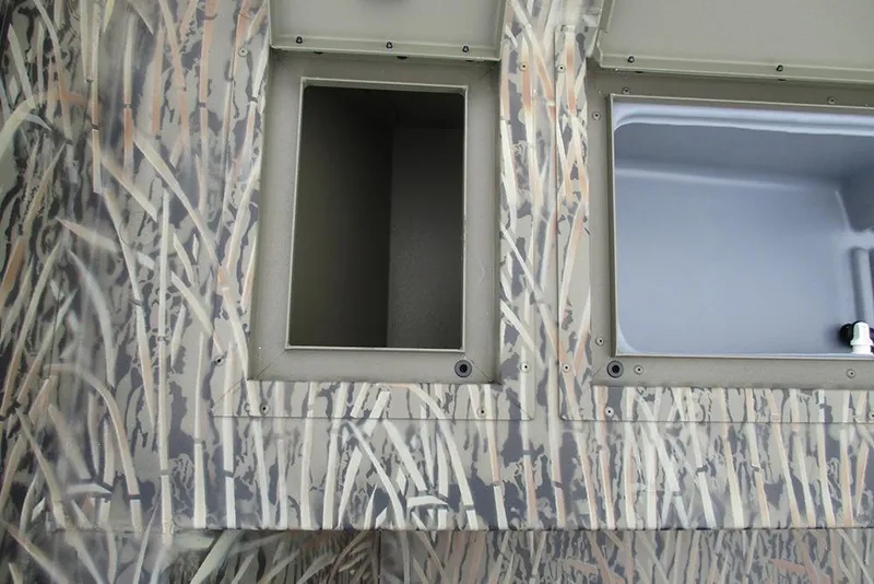 Slide: The Image of 2026 Tracker Grizzly 2072 CC boat storage compartments with camouflage design. - 16