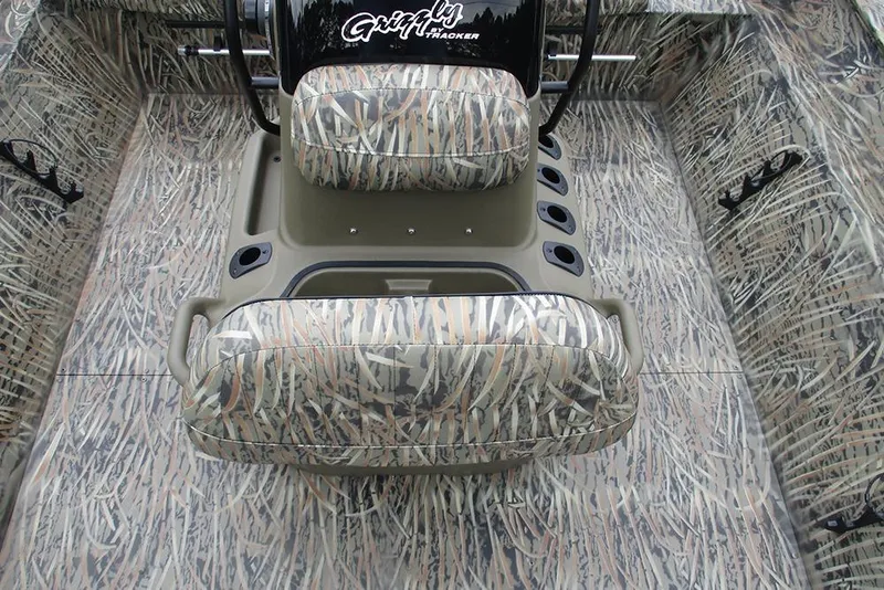 Slide: The Image of 2026 Tracker Grizzly 2072 CC boat interior with camouflage seating and flooring. - 18