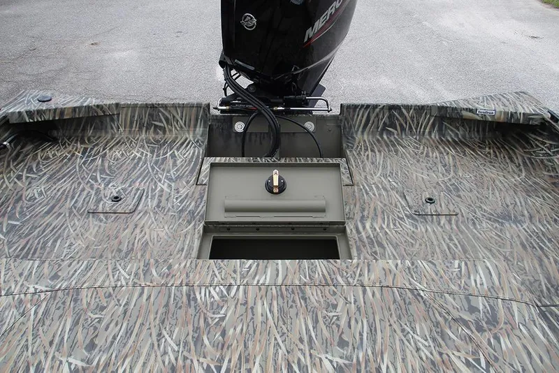 Slide: The Image of 2026 Tracker Grizzly 2072 CC boat with camo pattern and Mercury outboard motor. - 21