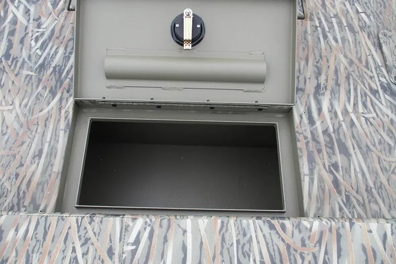 Slide: The Image of Open storage compartment on 2026 Tracker Grizzly 2072 CC boat with camouflage pattern. - 22