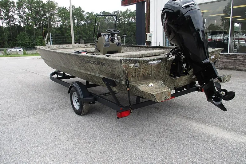 Slide: The Image of 2026 Tracker Grizzly 2072 CC boat on trailer, camo design, parked outdoors. - 7
